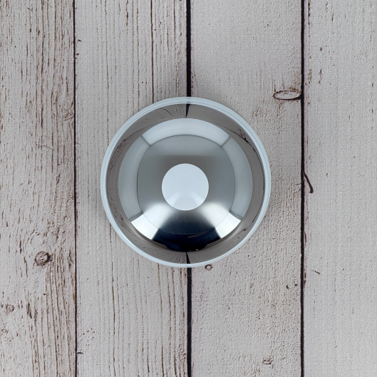 Close-up of the mirror-polished stainless steel lid with white porcelain knob, a signature Degrenne Salam design detail.